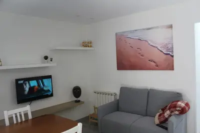 a living room with a couch and a flat screen tv at Casa dos avós in Ribadavia
