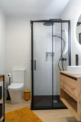 a bathroom with a shower with a toilet and a sink at Wanderlust Estudio in Ribadeo