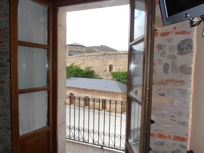 an open door to a balcony with a view at Hostal Virgen de la Encina in Ponferrada
