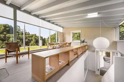 a kitchen with a table and chairs and large windows at Casas do Sarela by Upper Luxury Housing in Santiago de Compostela