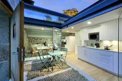 a kitchen and dining area with a sliding glass door at Casas do Sarela by Upper Luxury Housing in Santiago de Compostela