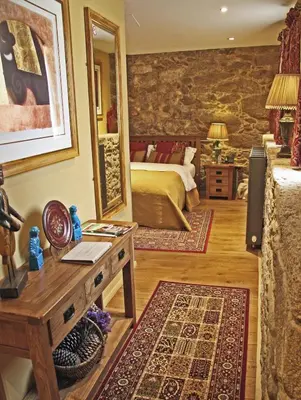 a bedroom with a bed and a mirror at Casa Camino Turismo Rural in Palas de Rei