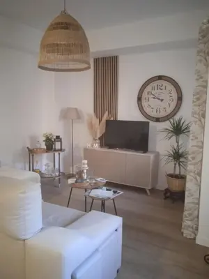 a living room with a white couch and a clock at Mi Camino in Sarria