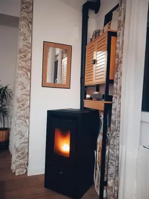 a black stove in a room with a mirror at Mi Camino in Sarria