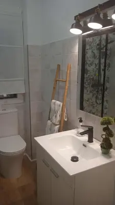 a bathroom with a sink and a toilet and a mirror at Mi Camino in Sarria