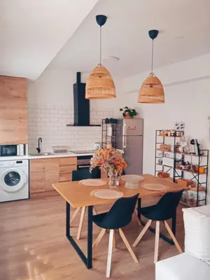 a kitchen with a wooden table and chairs at Mi Camino in Sarria