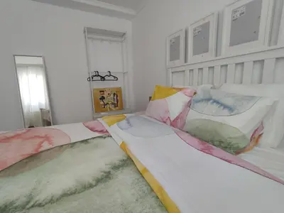 a bedroom with two beds and a window at Casa da Porta -----------------3 dormitorios in Lugo