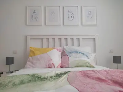 a bedroom with a bed with four pictures on the wall at Casa da Porta -----------------3 dormitorios in Lugo