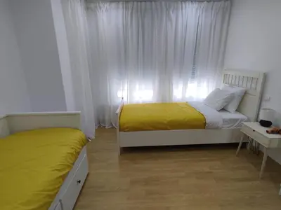 a bedroom with two beds and a window at Casa da Porta -----------------3 dormitorios in Lugo