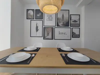 a dining room table with plates and a chandelier at Casa da Porta -----------------3 dormitorios in Lugo