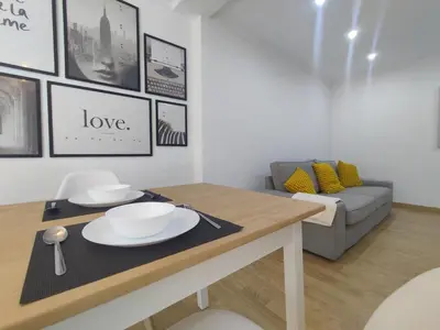 a living room with a table and a couch at Casa da Porta -----------------3 dormitorios in Lugo