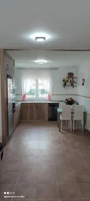 a room with a kitchen and a table and chairs at Casa Da Praia in Lugo