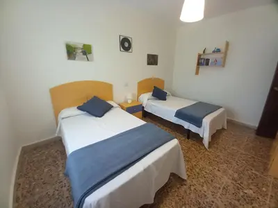 a hotel room with two beds with blue pillows at Casa Acantilado Barreiros in Barreiros