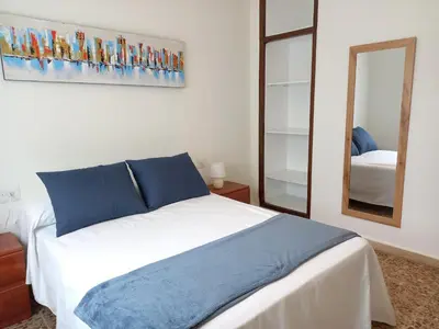 a bedroom with a large bed and a mirror at Casa Acantilado Barreiros in Barreiros