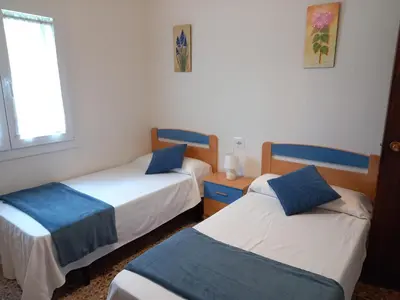 a room with two beds and a window at Casa Acantilado Barreiros in Barreiros