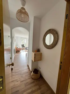a hallway with a door and a mirror on a wall at EnVIVEIRO Relax Total Playa de Covas in Viveiro