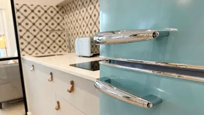 a blue refrigerator in a kitchen with a counter at Apartamentos Paseo Colón in Foz