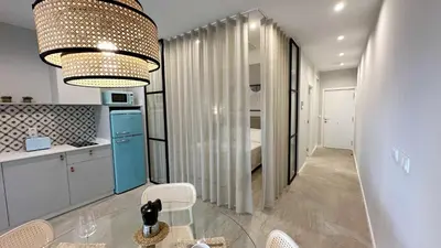 a kitchen with a glass table in a room at Apartamentos Paseo Colón in Foz