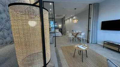 a living room with a room with a table and a living room at Apartamentos Paseo Colón in Foz