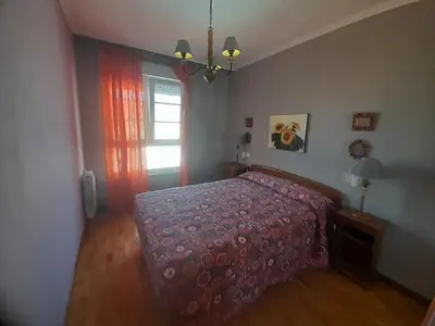 a bedroom with a bed and a window at EnFOZ Con Piscina Parking y Playa a 100 metros in Foz