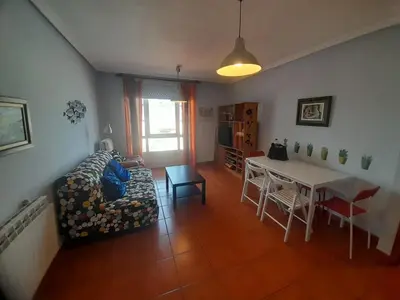 a living room with a couch and a table at EnFOZ Con Piscina Parking y Playa a 100 metros in Foz