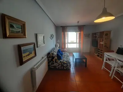 a living room with a couch and a table at EnFOZ Con Piscina Parking y Playa a 100 metros in Foz