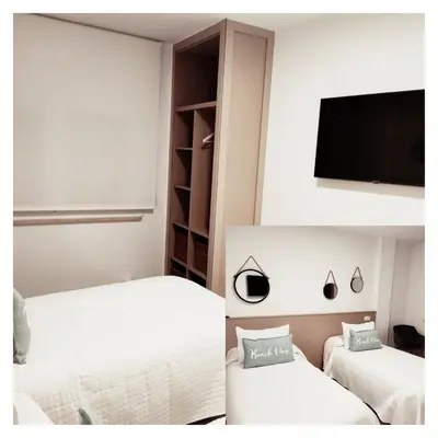 a bedroom with two beds and a flat screen tv at Apartamento Llave del Mar in Burela de Cabo