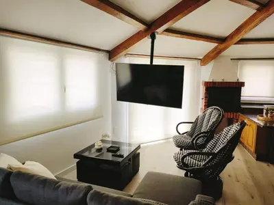 a living room with a couch and chairs and a flat screen tv at Apartamento Llave del Mar in Burela de Cabo