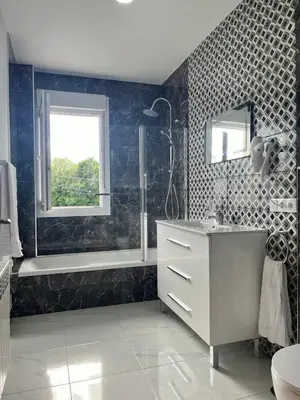 a bathroom with a sink and a tub and a window at A de Carmiña in A Coruña