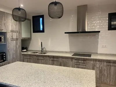 a kitchen with a sink and a counter top at Casa 1921 in Quinés