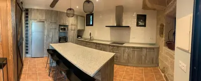 a kitchen with a counter and a island in it at Casa 1921 in Quinés