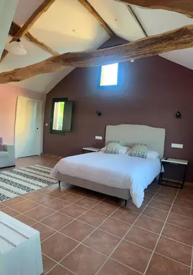 a bedroom with a white bed in a room at Casa 1921 in Quinés