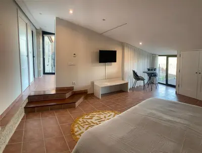 a bedroom with a bed and a television in it at Casa 1921 in Quinés