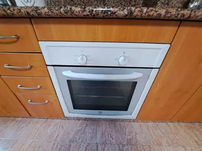 a white oven in a kitchen with wooden cabinets at Grenxo in Santiago de Compostela