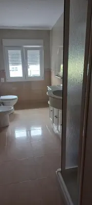 a bathroom with three sinks and two toilets at Grenxo in Santiago de Compostela