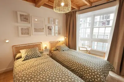 a bedroom with two beds next to a window at Viveiro Dreams in Viveiro