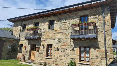 an old stone building with windows and balconies at Casa El Filandar in Ríonegrito