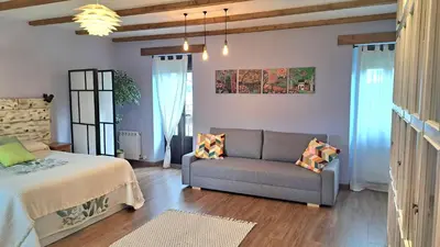 a living room with a couch and a bed at Casa El Filandar in Ríonegrito