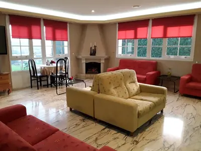 a living room with a couch and chairs and a fireplace at Hotel Castro in Santiago de Compostela