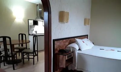 a small room with a bed and a table with a tableablish at Hotel Castro in Santiago de Compostela