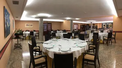 a large dining room with white tables and chairs at Hotel Castro in Santiago de Compostela