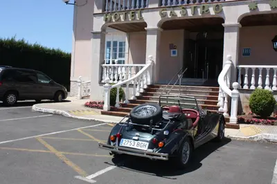 an old car parked in a parking lot in front of a building at Hotel Castro in Santiago de Compostela