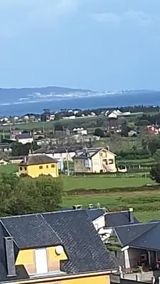 a view of a town with houses and the ocean at Apartamento con vistas Barreiros in Barreiros