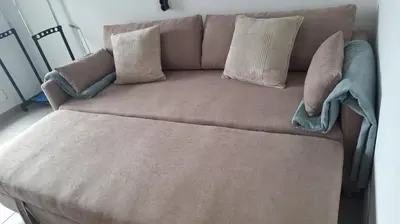 a brown couch with pillows on top of it at Apartamento con vistas Barreiros in Barreiros