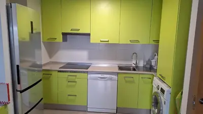 a kitchen with lime green cabinets and a dishwasher at Apartamento con vistas Barreiros in Barreiros