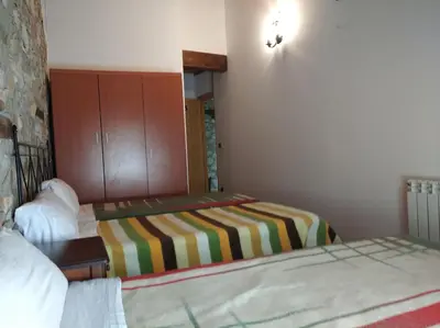 a hotel room with two beds and a mirror at Casa Rural Borrenes las Médulas in Borrenes