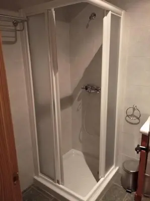 a shower with a glass door in a bathroom at Casa Rural Borrenes las Médulas in Borrenes