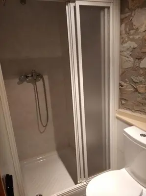 a shower with a glass door in a bathroom at Casa Rural Borrenes las Médulas in Borrenes