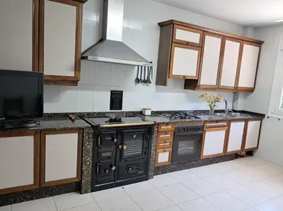a kitchen with a stove top oven in a kitchen at Casa vacacional amplia in Carracedo