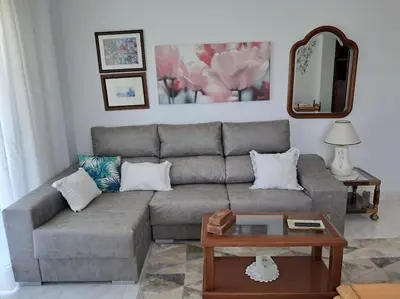 a living room with a couch and a table at Casa vacacional amplia in Carracedo